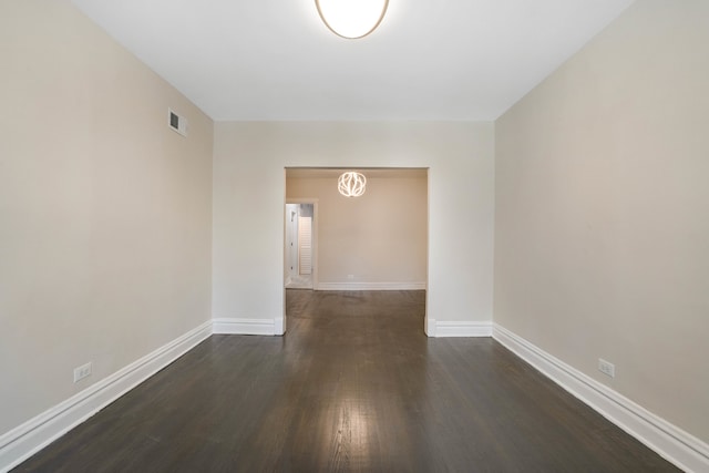 unfurnished room featuring dark hardwood / wood-style flooring