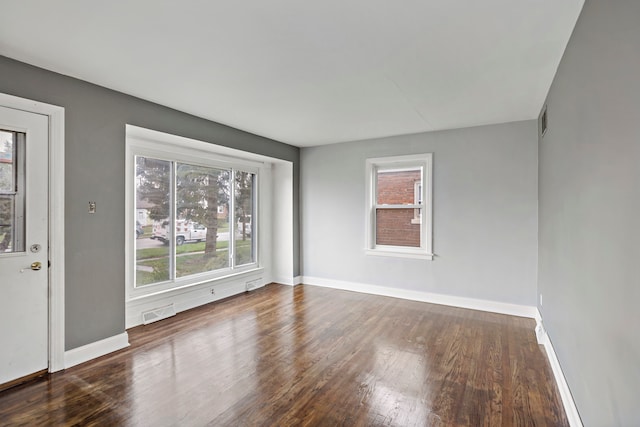 empty room with dark hardwood / wood-style floors