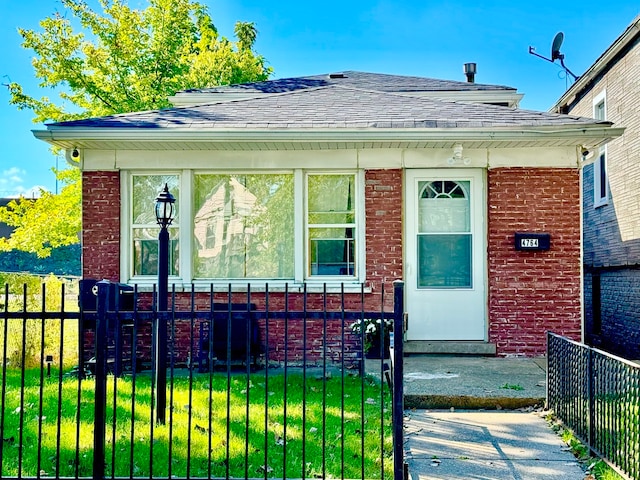 bungalow-style house with a front yard