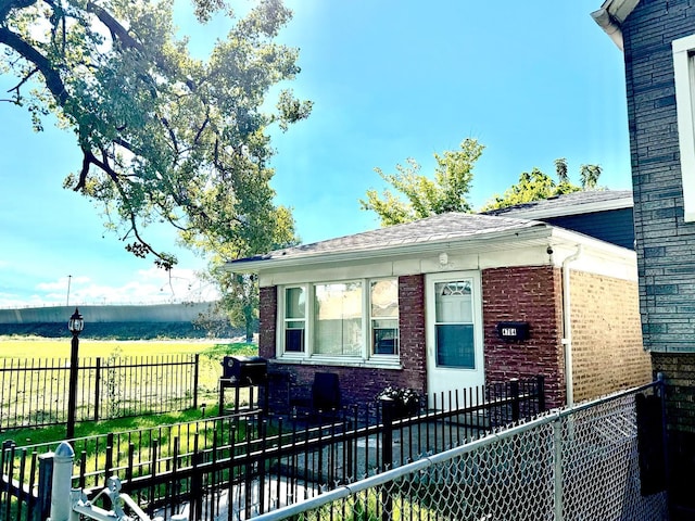 4764 S Shields Ave, Chicago, IL 60609 - view of front of property featuring brick siding, a fenced front yard, and roof with shingles