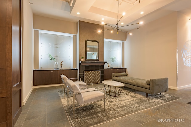 interior space featuring a raised ceiling and a chandelier