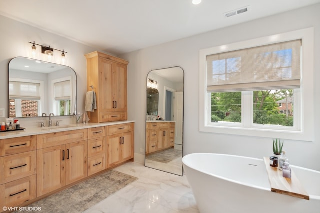 bathroom featuring vanity and a tub to relax in