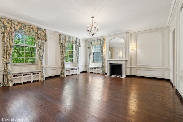 unfurnished living room with crown molding, a fireplace, and dark hardwood / wood-style flooring