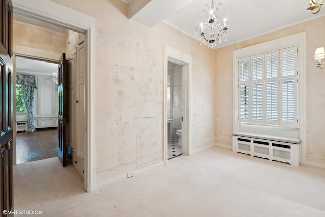 interior space featuring wood-type flooring, a chandelier, and crown molding