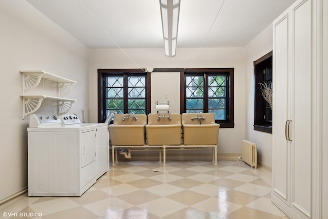 laundry room with washer and clothes dryer and radiator