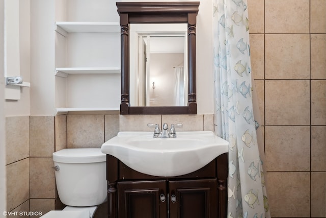 bathroom featuring tile walls, vanity, and toilet