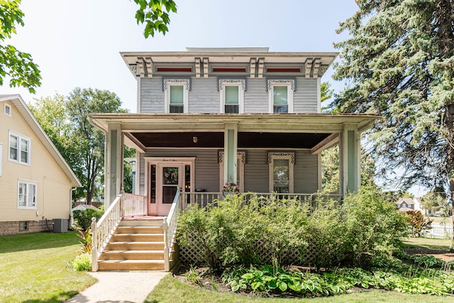 italianate-style house with a front lawn and a porch