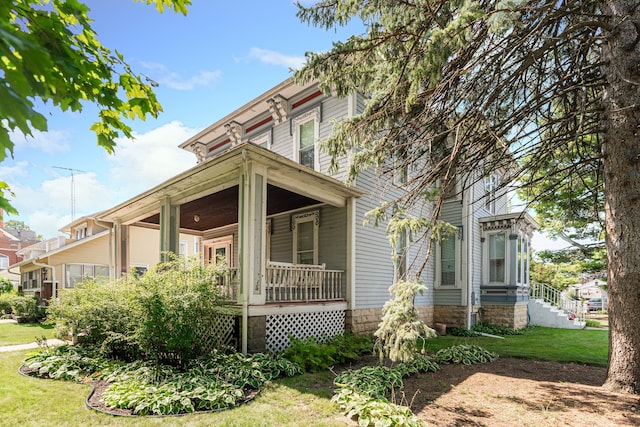 view of side of home with a yard