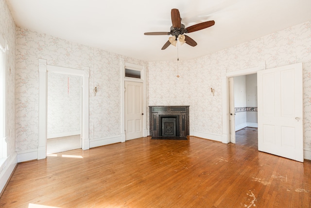 unfurnished living room featuring wood-type flooring and ceiling fan