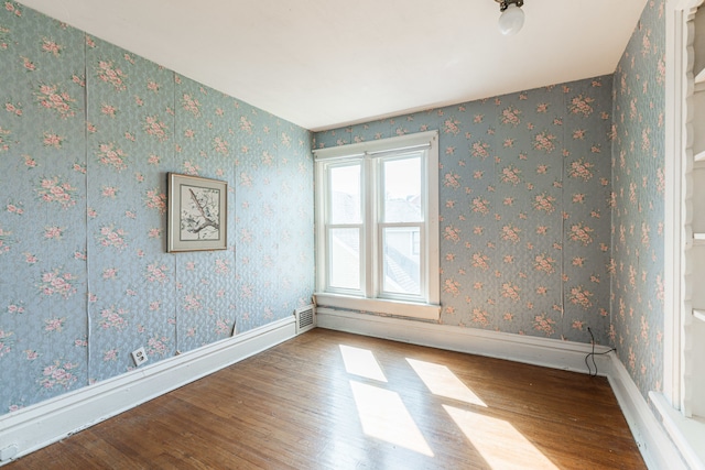 empty room featuring wood-type flooring