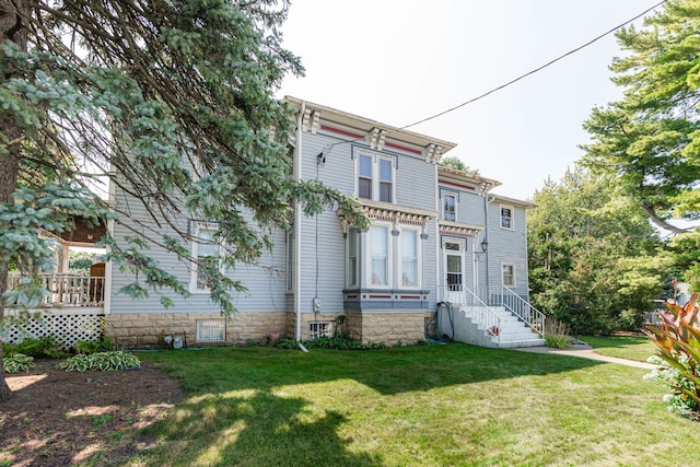 rear view of house with a lawn