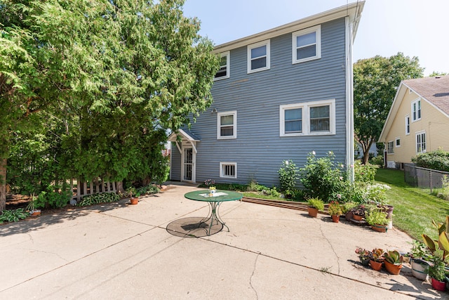 back of house featuring a patio area and a yard