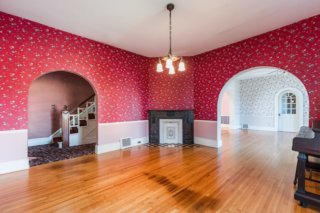 interior space with wood-type flooring and a notable chandelier