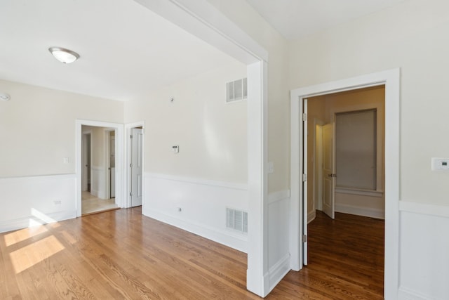 spare room with wood-type flooring