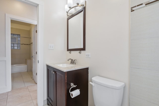 full bathroom featuring vanity, tiled shower / bath combo, toilet, and tile patterned floors