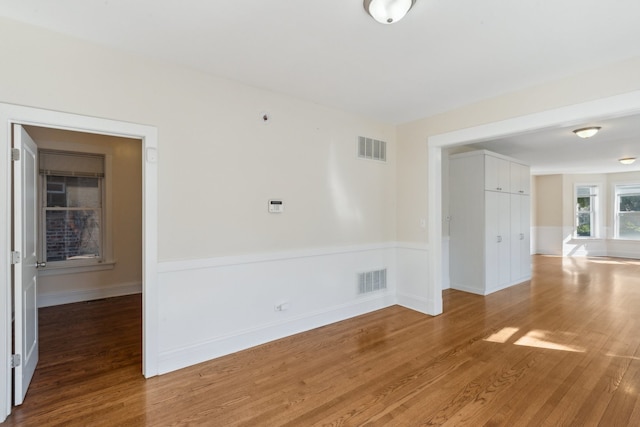 unfurnished room featuring hardwood / wood-style flooring