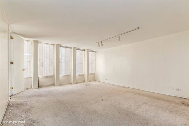 interior space with light carpet and rail lighting