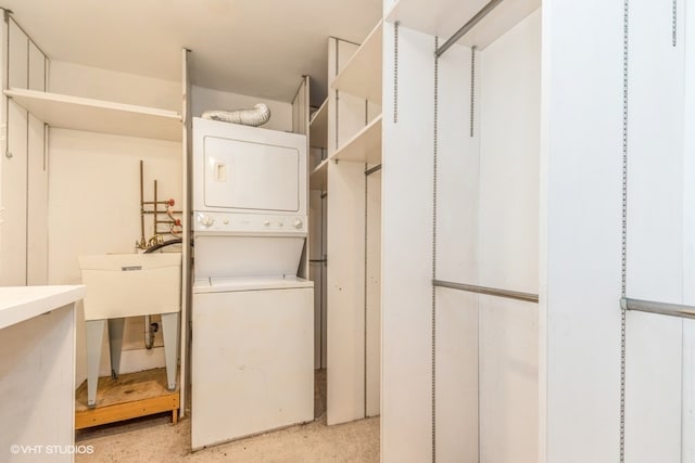 washroom featuring stacked washer / drying machine