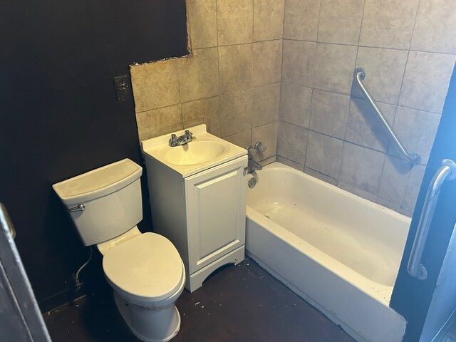 full bathroom featuring tile walls, washtub / shower combination, vanity, and toilet