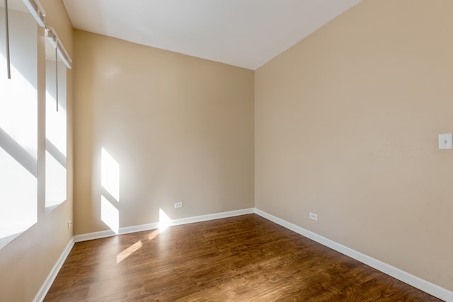 empty room with hardwood / wood-style flooring