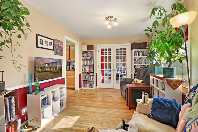 living room with french doors and light hardwood / wood-style floors