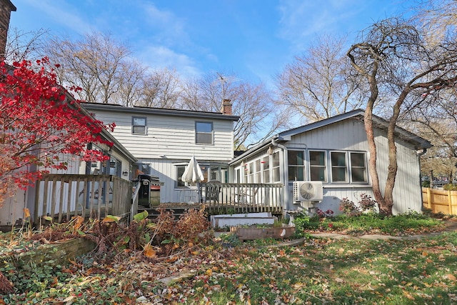 rear view of house with a deck and ac unit