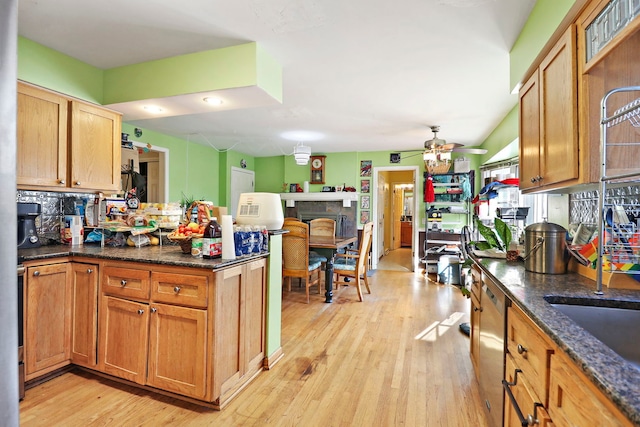 kitchen featuring ceiling fan, decorative backsplash, light hardwood / wood-style flooring, and kitchen peninsula