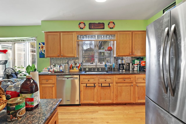 kitchen with plenty of natural light, backsplash, sink, and stainless steel appliances