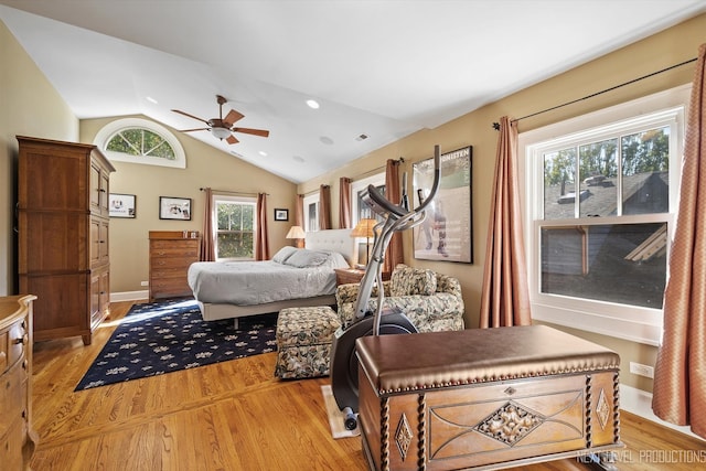 bedroom featuring ceiling fan, light hardwood / wood-style floors, and vaulted ceiling