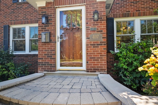 view of exterior entry with a patio area