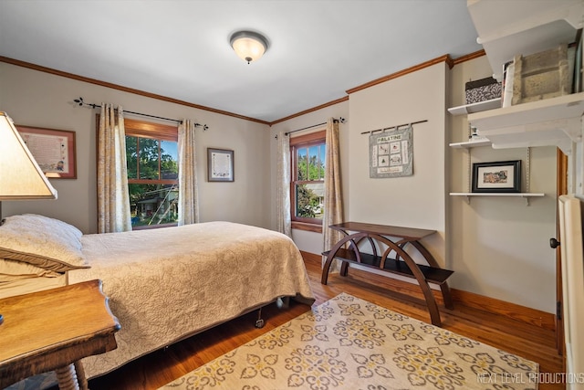 bedroom featuring light wood-type flooring and crown molding