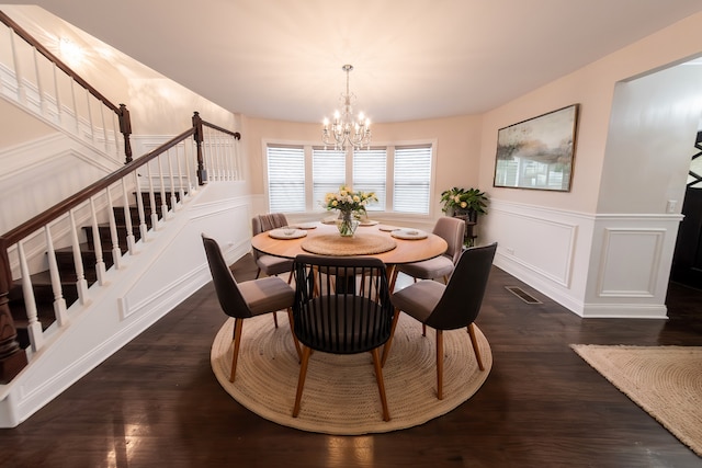 dining space featuring a chandelier and dark hardwood / wood-style flooring