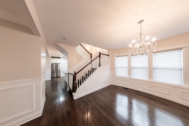 interior space featuring dark hardwood / wood-style floors and a chandelier