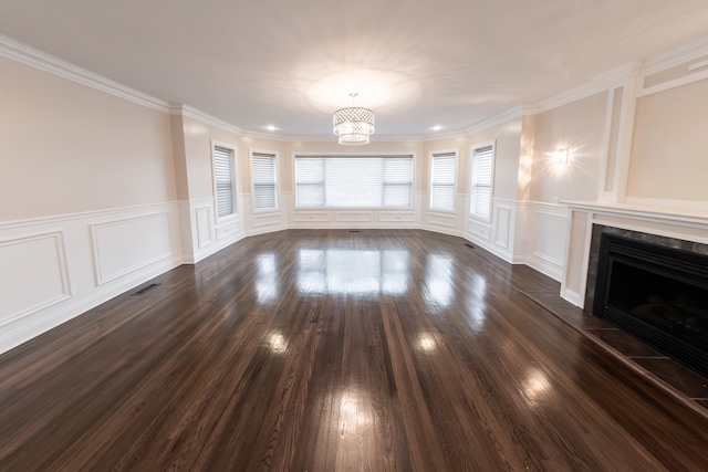 unfurnished living room featuring ornamental molding, dark hardwood / wood-style floors, and a fireplace