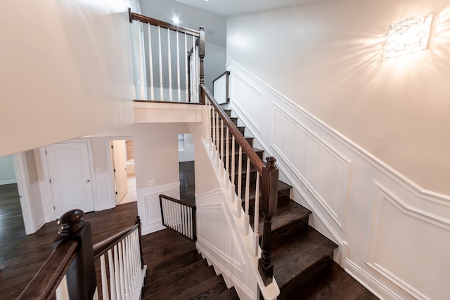 staircase with hardwood / wood-style floors