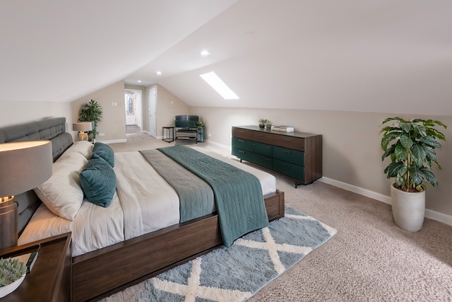 bedroom with lofted ceiling with skylight and light colored carpet