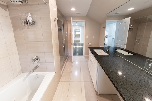 bathroom with vanity, vaulted ceiling, plus walk in shower, and tile patterned floors