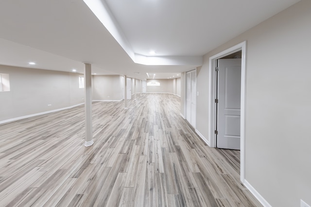 basement with light hardwood / wood-style floors