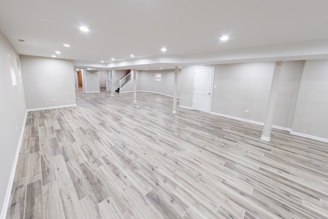 basement with light hardwood / wood-style floors