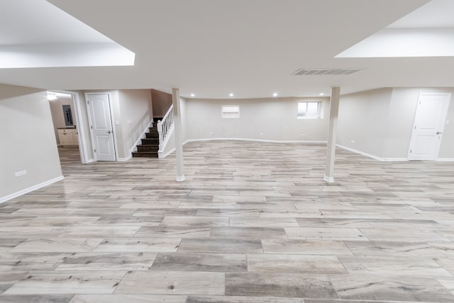 basement with light hardwood / wood-style flooring