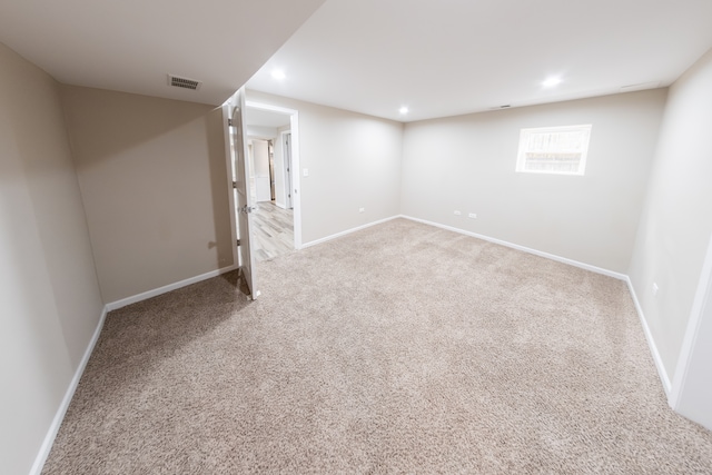 basement featuring light carpet