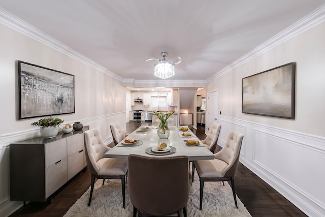 dining area featuring an inviting chandelier, ornamental molding, and dark hardwood / wood-style flooring