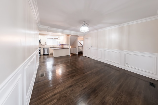 interior space with ornamental molding, an inviting chandelier, and dark hardwood / wood-style floors