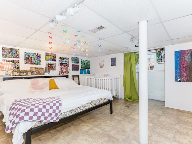 bedroom featuring a drop ceiling