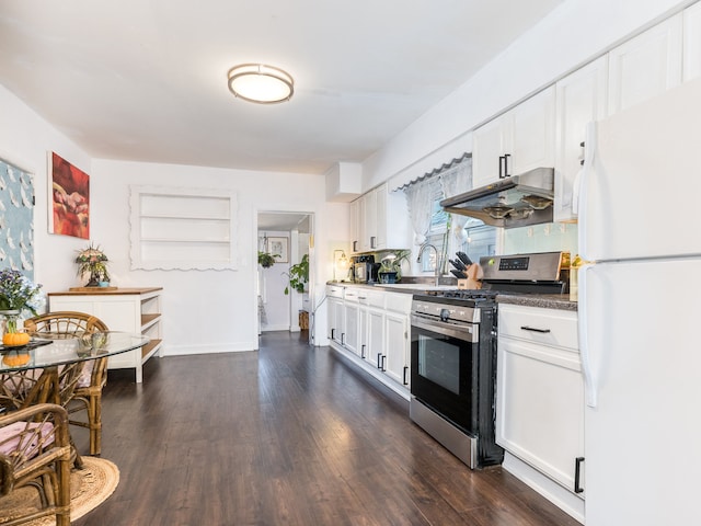 kitchen with sink, white fridge, stainless steel range with gas stovetop, white cabinetry, and dark hardwood / wood-style flooring