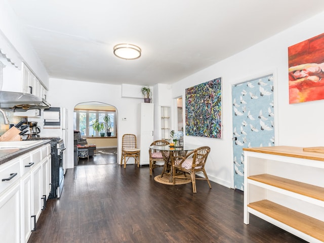 kitchen with white cabinets, electric stove, and dark hardwood / wood-style floors