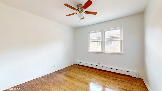 empty room with light hardwood / wood-style floors, baseboard heating, and ceiling fan