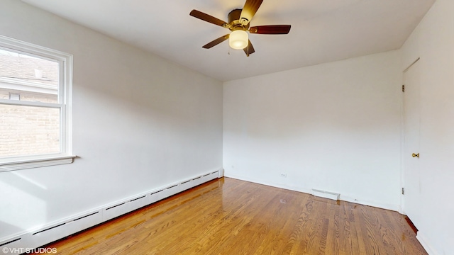 unfurnished room with ceiling fan, a baseboard heating unit, and hardwood / wood-style flooring