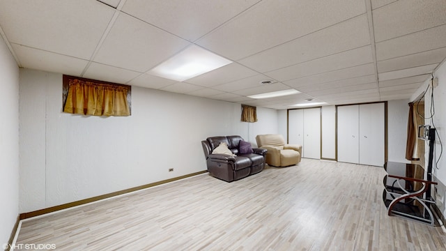 unfurnished room with light hardwood / wood-style flooring and a paneled ceiling