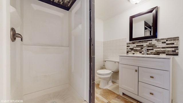 bathroom featuring tile walls, walk in shower, tile patterned floors, vanity, and toilet